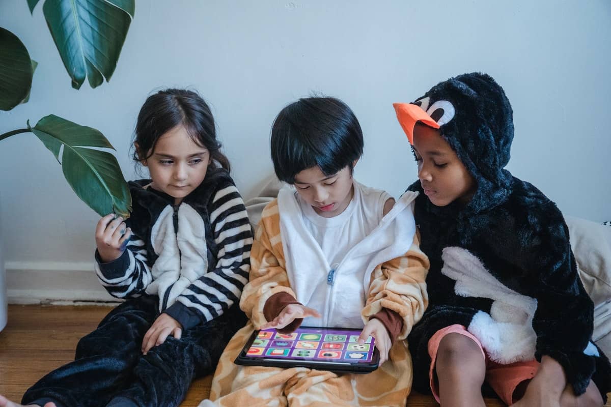 Three kids in costumes learning to code on a tablet Studying Computer Science Before College