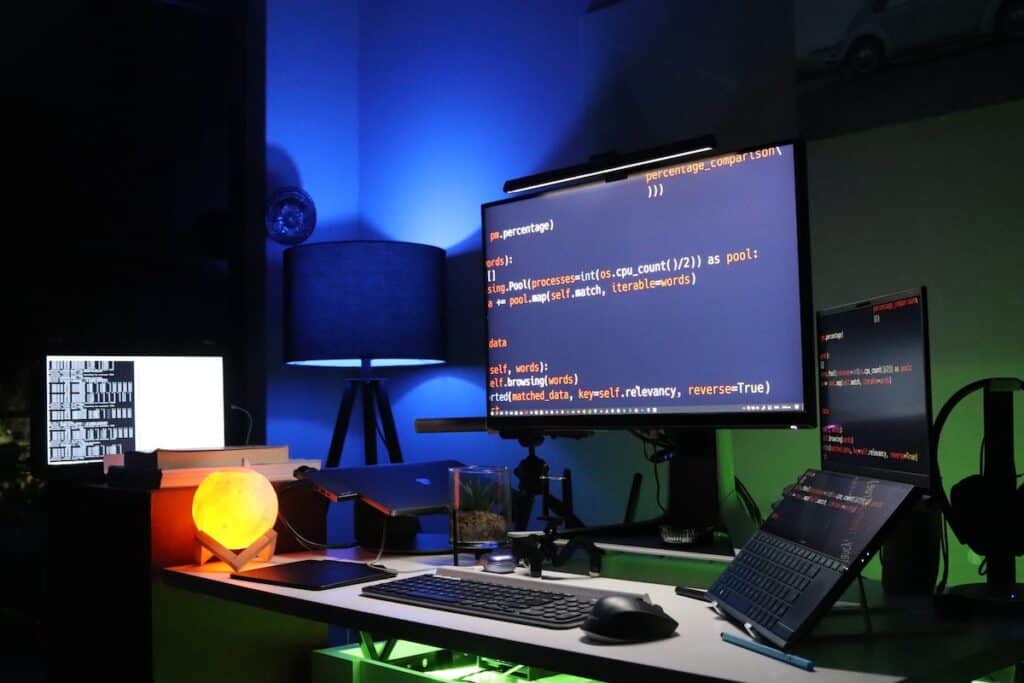 Desk set up with multiple screens displaying lines of code Best Computer Science Certifications
