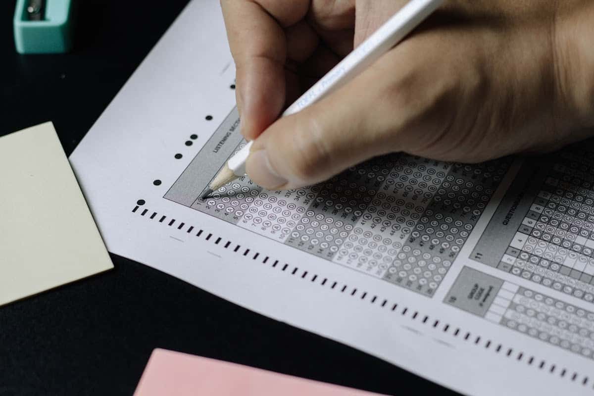 Person filling in a bubble on a Scantron sheet with a white pencil what is a highschool equivalency