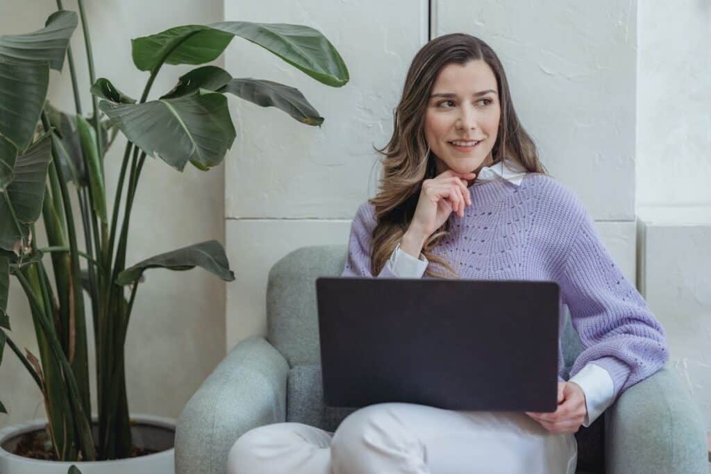 A woman sitting on a chair with a computer on her lap. How to Make a Career Change