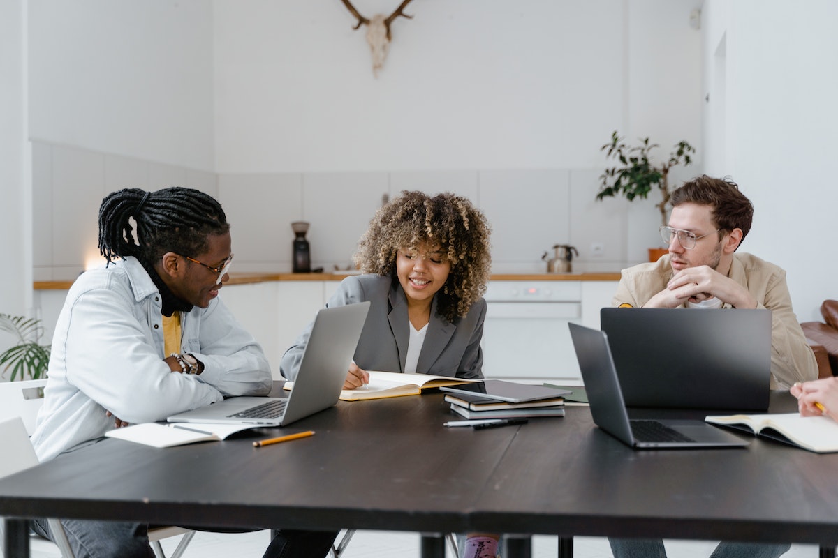 A woman and two men on their working together