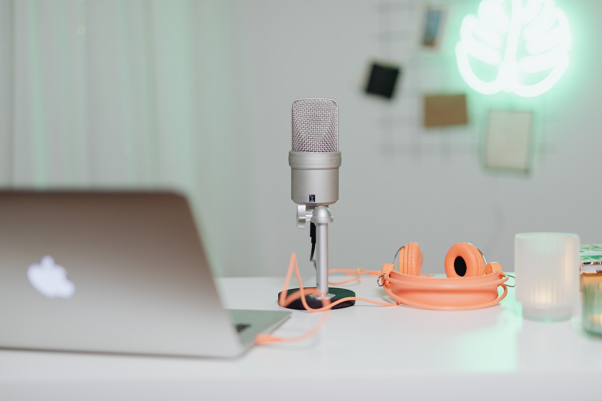 The desk of a content creator with a clean setup for voice recording.