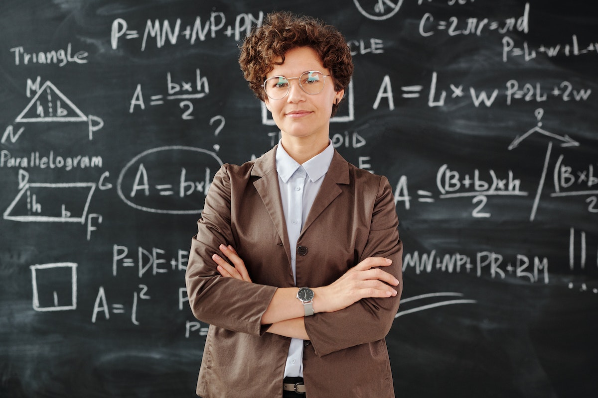 A teacher standing in front of blackboard
