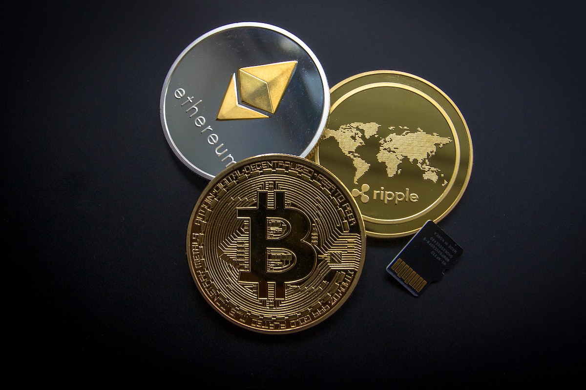 Three cryptocurrency coins Bitcoin, Ethereum, and Ripple
