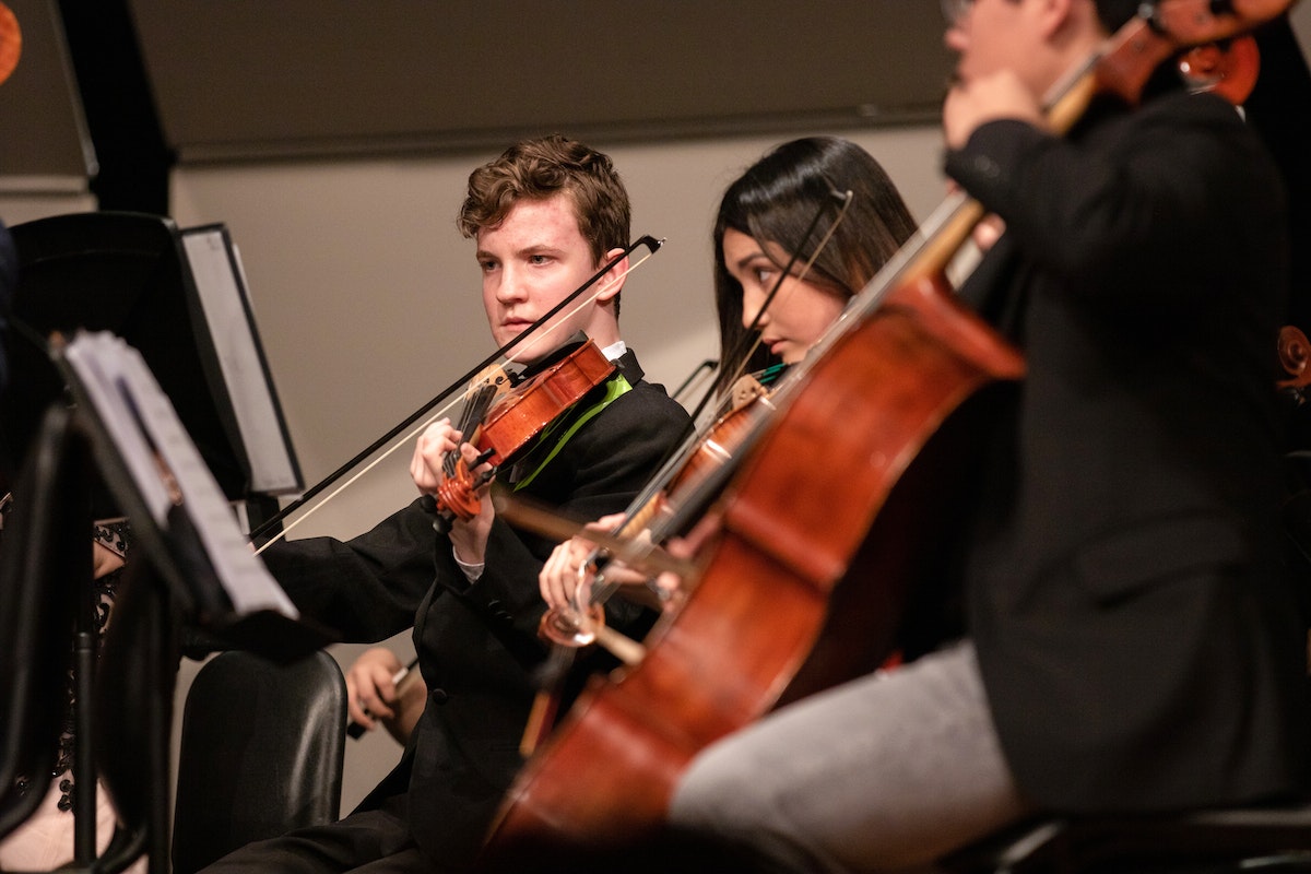 A group of music students playing in an orchestra.
